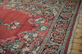 Vintage Arak carpet corner showing the detailed floral border, short pile, and original selvage.