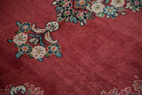 Even, short pile of a vintage Arak carpet showing a floral bouquet in gem-like tones on a red field.