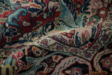 Dense hand-knotted pile of a vintage Arak carpet in ruby, jade, and sapphire blue floral tones.