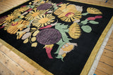 Close-up of the clean white fringe and gold border on a black Art Deco carpet.