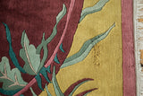 Intricate contoured carving on saffron yellow and burgundy Arts and Crafts rug.