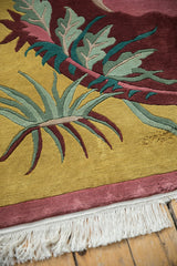 Carved saffron yellow, burgundy, and teal Arts and Crafts rug pattern and fringe.