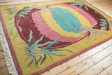 White fringe and intact burgundy side cord selvage on a vintage Indian Arts and Crafts rug.