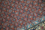 Detail of the rust-colored Herati pattern and dense pile next to the multi-color border.