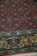 Angled detail of the full pile showing the Samovar border and rust-colored Herati field.