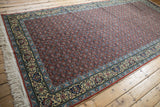 Angled full-length view of the vintage Bulgarian runner's rust Herati field and floral borders.
