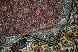 Plush, even pile of a vintage Tabriz design rug showing rust, blue, and buttercream Herati patterns.