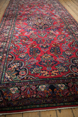Cherry red field of the vintage Dargezine rug, displaying intricate floral bouquets and vines.
