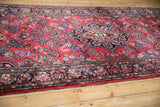 Vintage Dargezine runner's intricate floral border in cherry red, navy, and green.