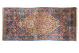 Vintage Persian Kerman runner with a thousand-flower ivory field and scalloped indigo blue borders.