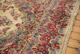 Vintage Kazvin carpet's curvilinear floral design in red, sky blue, ivory, and fringed edge.