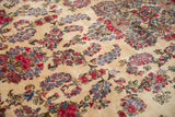 Vintage Kerman carpet: intricate raspberry, sky blue, and emerald floral sprays on ivory.