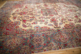 Vintage Persian Kerman carpet's detailed blue border with cartouche and ruby red floral designs.