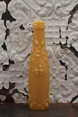 Antique bottle beeswax candle with embossed rose, citrus, and leaf details.