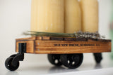 Stamped Old New House branding on the torched wood side of a miniature industrial cart.