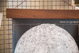 Detail of the vintage moon chart with intricate black and white lunar topography and walnut rod.