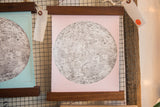 Pale ballerina pink moon chart art print showcasing intricate lunar details and walnut wood rods.