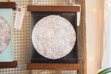 Intricate lower right detail of the black and white moon chart with walnut rod.