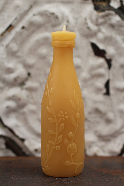Antique Bottle Beeswax Candle with embossed golden floral vines, leaves, citrus blossoms, and limes.