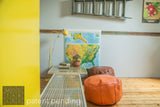 Long, low-slung Mod Sled coffee table styled with leather ottomans and a vintage map.