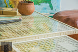 Intricate grid of natural wood slats seen through the glass top of a handmade Mod Square Table.