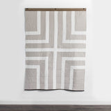 Louise Gray Quilt bottom right corner, featuring white, tan geometric pattern and black trim.