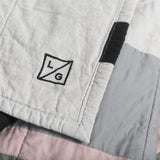 Louise Gray logo on quilted cotton, showcasing tan, black, pewter, and rose fabric.
