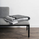 Folded Louise Gray No. 9 quilt featuring dark gray, light gray, and black stripes.