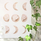 Katelyn Morse art print with nine watercolor moon phases in mottled beige and brown.