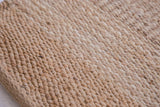 Handmade pure jute rug texture with subtle light and dark tone striations.