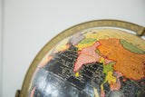 Cram's black globe detail with Arabian Sea, colorful Asian map, and brass ring.