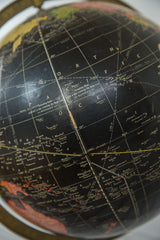 Close-up of the vintage Cram's black globe surface, displaying Pacific Ocean islands and grid lines.