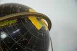 Mid Century Cram's black globe, yellow Antarctica, white grid lines, and brass meridian.