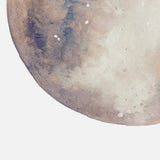 Close-up of neutral moon art print, watercolor texture with soft beige, gray, and blue tones.