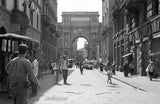 Melissa Dilmaghani's black and white photograph of a Florence street with a grand archway.