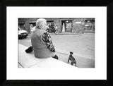 Framed black and white street portrait of an elderly woman and dog in Florence, Italy.