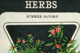 Close-up of 'HERBS SUMMER SAVORY' text on birchwood art, showing natural wood grain.