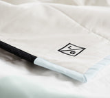 Embroidered LG logo on white quilted cotton, with black and seafoam trim.