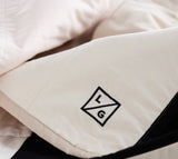 Louise Gray Quilt embroidered LG logo on khaki cotton fabric with black trim.
