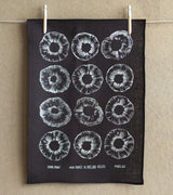 Hand-printed black and white tea towel with circular spore graphic on fog linen.