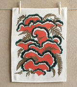 Makelike tea towel with graphic red, black, turquoise, gold botanical print on white linen.
