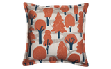 Woodland graphic pillow with red, blue trees and zigzag dotted paths on cream.