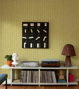 Yellow Fishbone Retro Wallpaper featuring subtle yellow and metallic gold vertical stripes.
