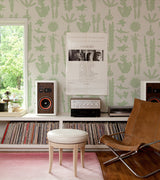 Light grey wallpaper with a hand-printed green cactus and succulent plant pattern.