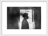Framed antique revival black and white print, boy's silhouette with pipe.
