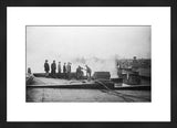 Framed antique experimental black and white photograph of men firefighting on a rooftop.