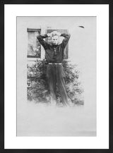 Framed experimental black and white antique photograph of a boy posing.