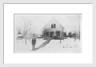 White framed antique experimental photo, surreal figure in a snowy landscape.