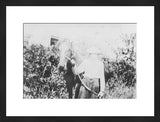 Framed antique black and white photograph of a woman with a horse.