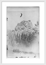 Framed black and white photograph of a large rock and atmospheric trees.